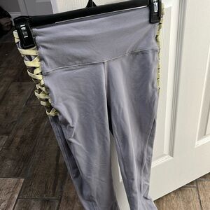 Fabletics grey leggings with yellow crisscross design